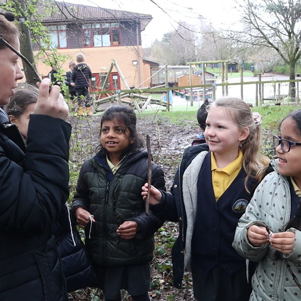 Children and Teacher with Sticks.jpg