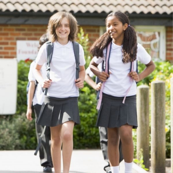 two school girls walking together and smiling.jpg