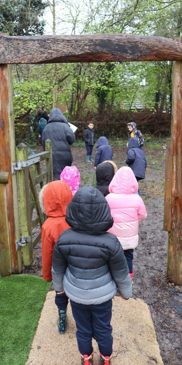 children walking away outdoors in a line.jpg