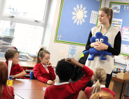 Teacher in a classroom with a Jigsaw character