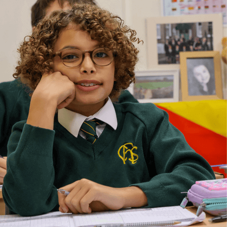 Boy with arms crossed and hand on his face