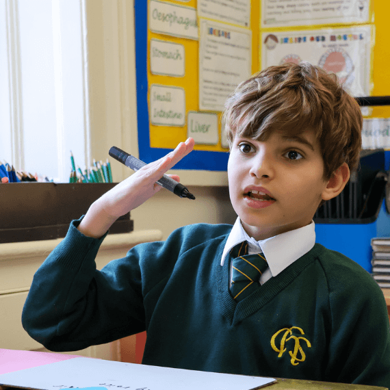 Boy talking holding a pen