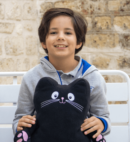 Boy on a chair holding Jerry cat