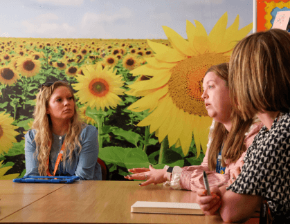 Teachers discussing around a table