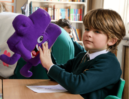 Boy holding a Jigsaw character
