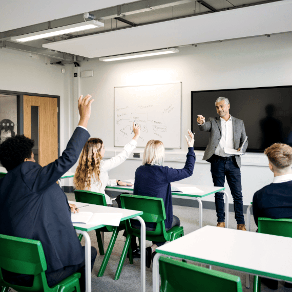 Teacher taking questions from pupils