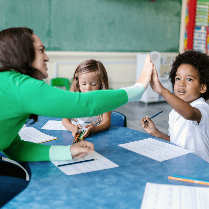 Teacher and childing having a high five