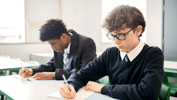 Two pupils working at their desks