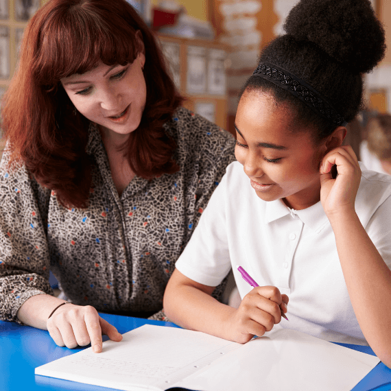 Teacher helping pupil