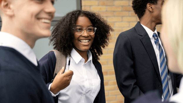 A girl smiling and talking to friends