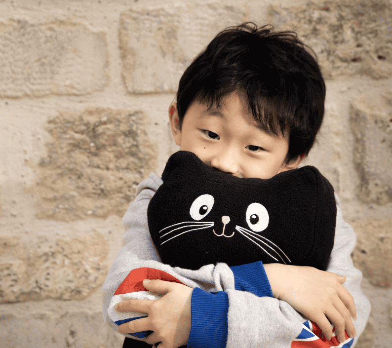 Child holding a Jigsaw character and Jerry cat