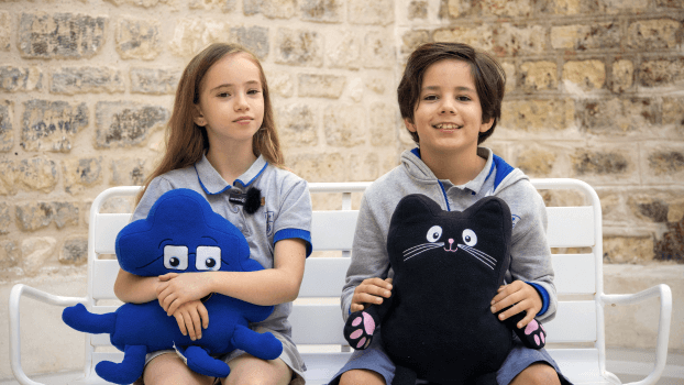 Two children holding a Jigsaw character and Jerry cat