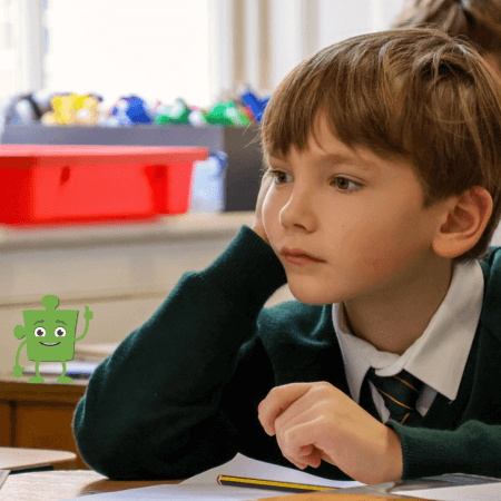 Boy sitting with his hands on his face
