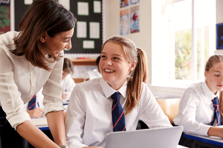 A pupil and teacher sitting together