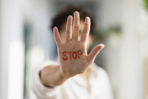 someone holding their hand up with STOP on it