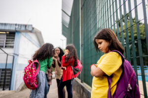 group of girls bullying a young girl