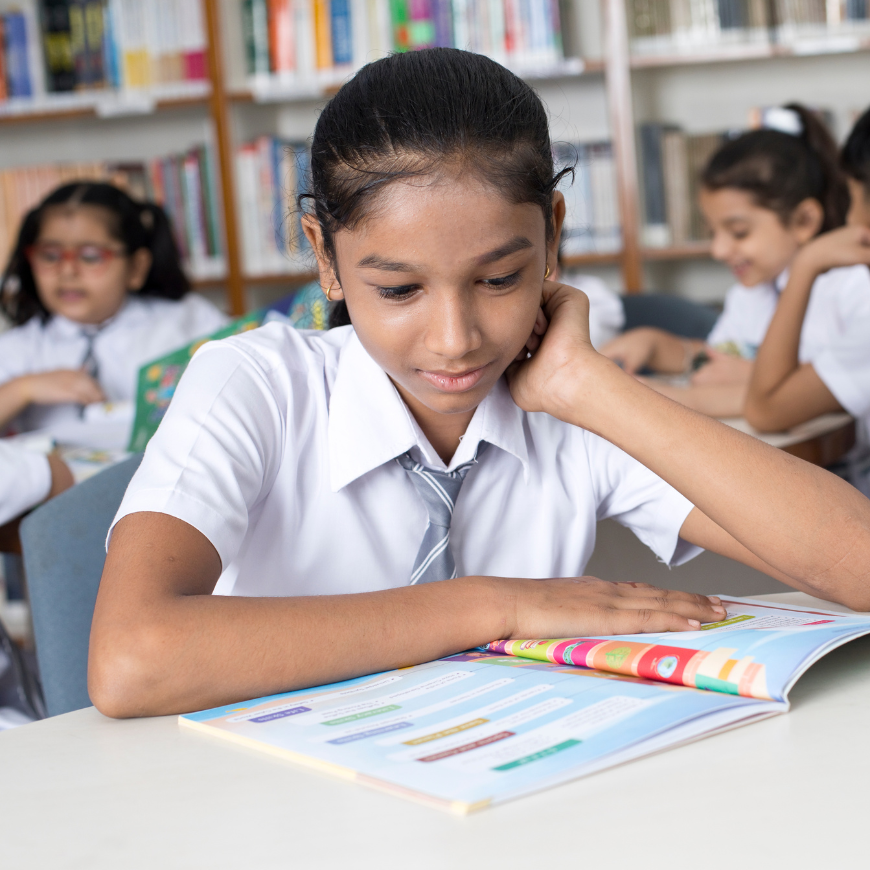 Girl reading for World Book Day with Jigsaw